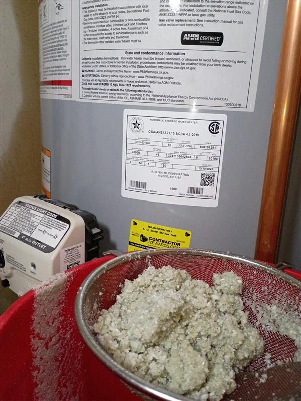 Before service: Two years of sediment pulled out of a 50-gallon gas tank during a flush and service visit. Sediment like this is what shortens tank life and causes rumbling and slow recovery.
