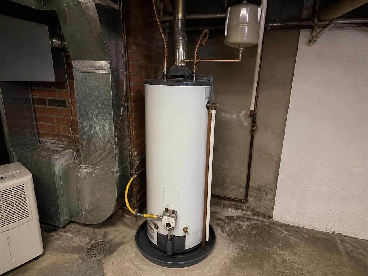Gas tank water heater in a residential mechanical room