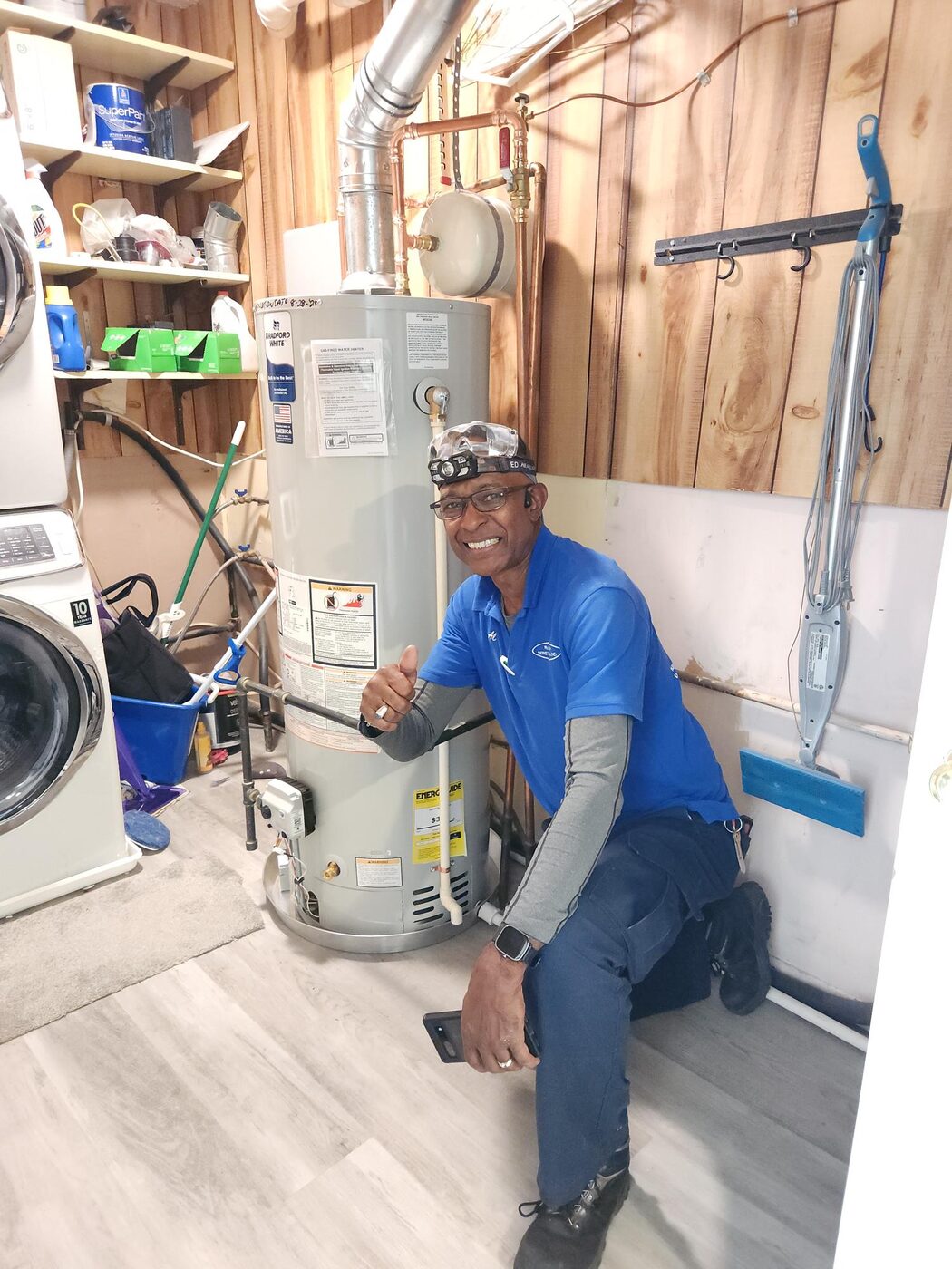 Hot Water Express technician beside a completed water heater installation