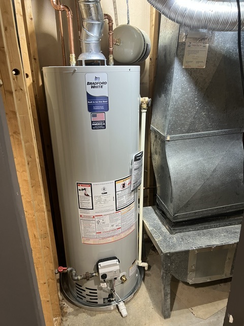 Bradford White gas tank water heater installed beside residential HVAC equipment by Hot Water Express.