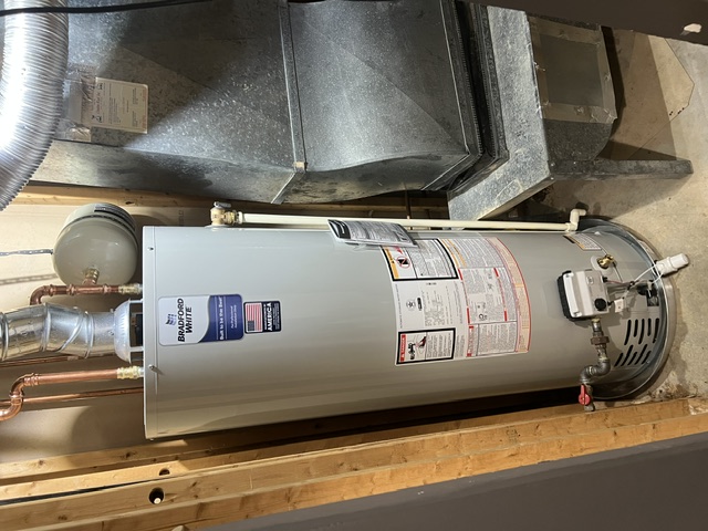 Bradford White gas tank water heater installed beside residential HVAC equipment by Hot Water Express.