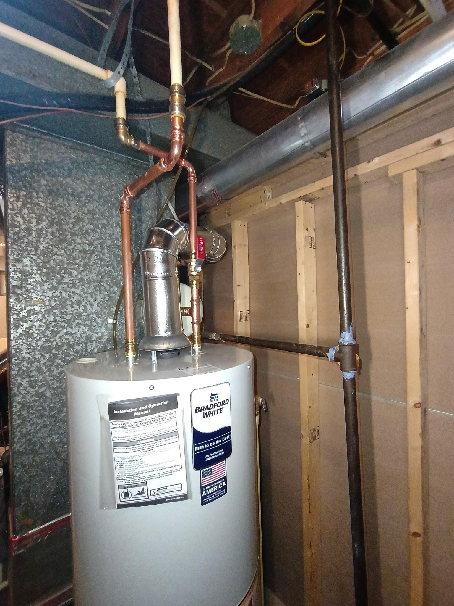 New metal flue connection above a Bradford White water heater in Temple Hills